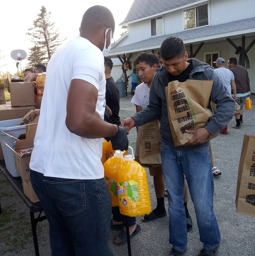 People distributing food at outside help center